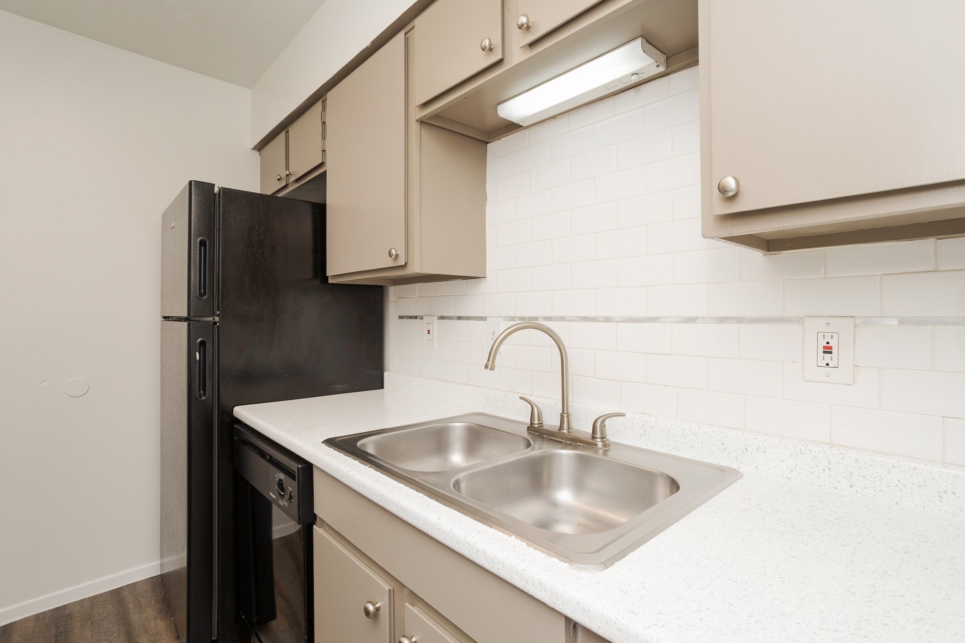 Apartment kitchen sink and appliances at Josey Place